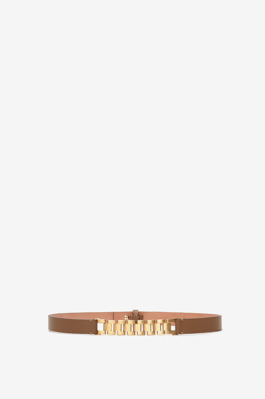 A Victoria Beckham khaki-brown calf-leather finish belt with a golden metallic buckle, consisting of multiple interlocking pieces, displayed on a white background.