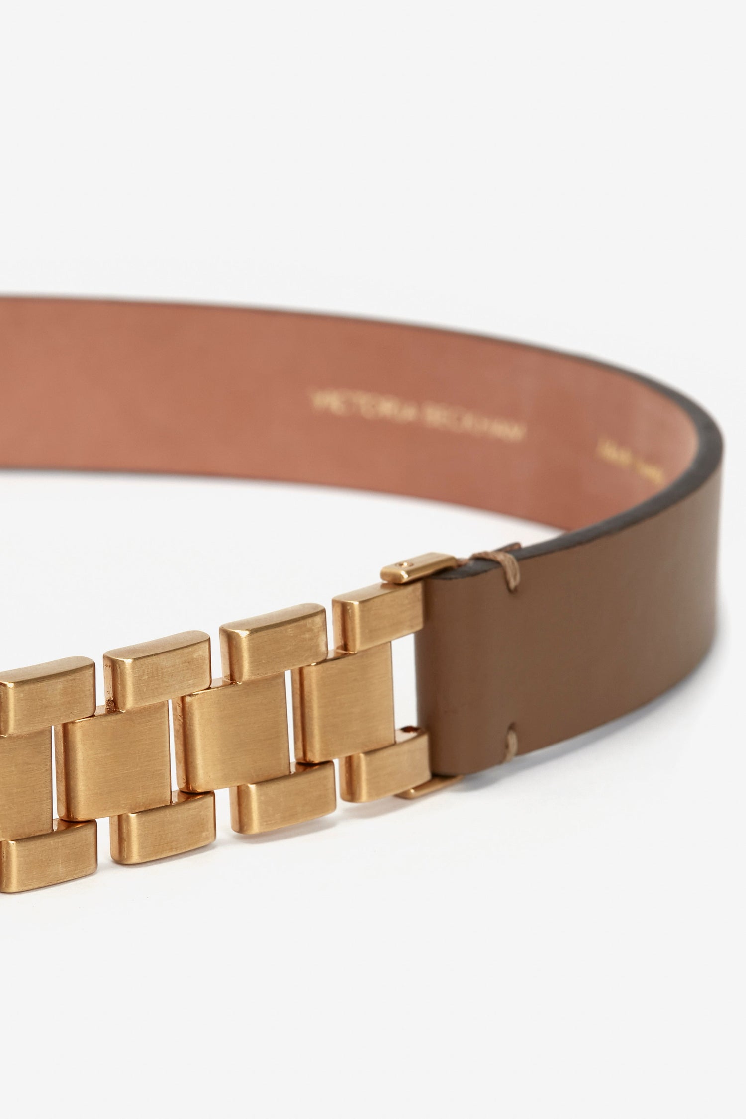 Close-up of a Victoria Beckham Watch Strap Detail Belt in Khaki-Brown with a golden metallic buckle, showing detailed texture and calf-leather finish inside.