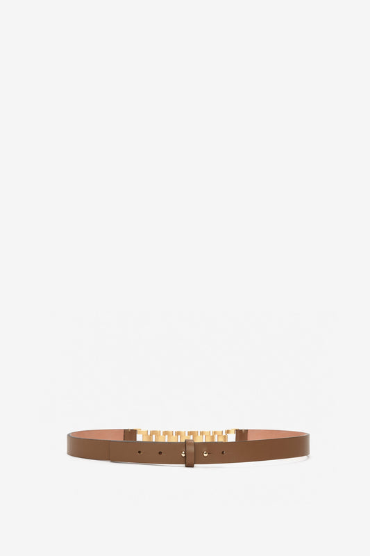 A slim Victoria Beckham khaki-brown calf-leather belt with a golden square buckle, positioned horizontally on a white background.
