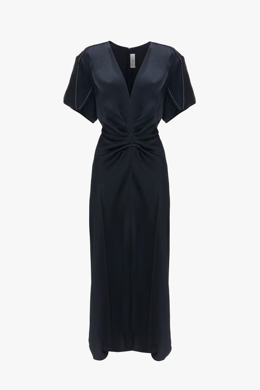 A Exclusive Gathered V-neck midi dress in navy by Victoria Beckham with short sleeves and a twisted knot detail at the waist, displayed against a white background.