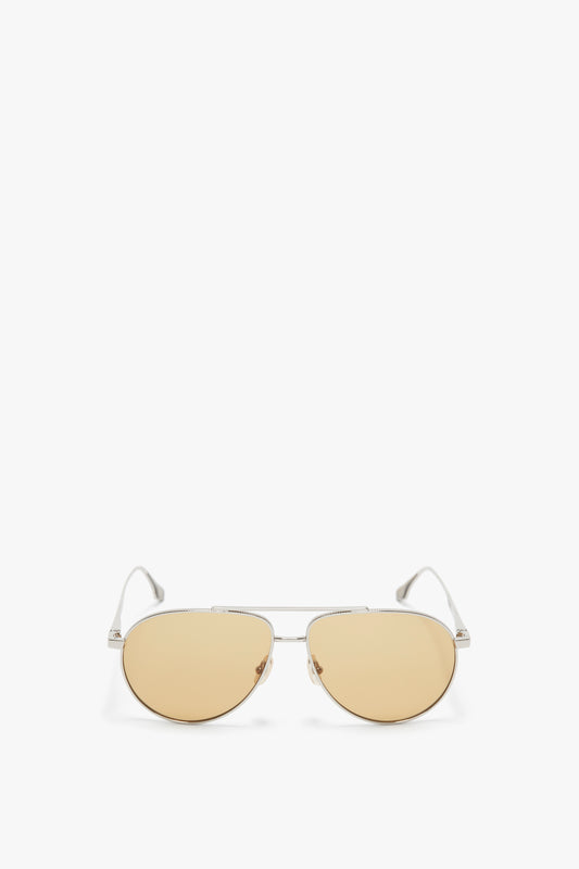 A pair of Victoria Beckham aviator sunglasses with thin metal frames and light amber-tinted lenses, featuring adjustable nose pads, isolated on a white background.