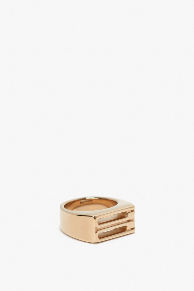 Exclusive Frame Signet Ring In Gold by Victoria Beckham, with a gap and two parallel embedded lines, displayed on a white background.
