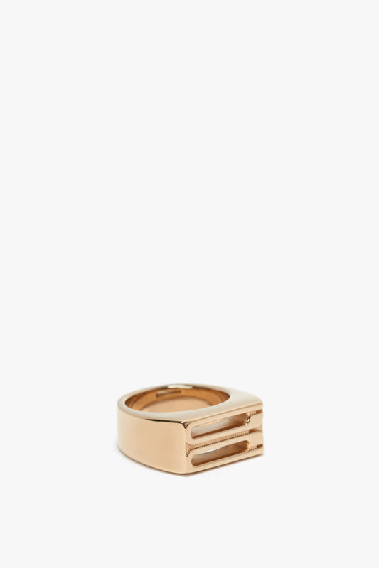Exclusive Frame Signet Ring In Gold by Victoria Beckham, with a gap and two parallel embedded lines, displayed on a white background.
