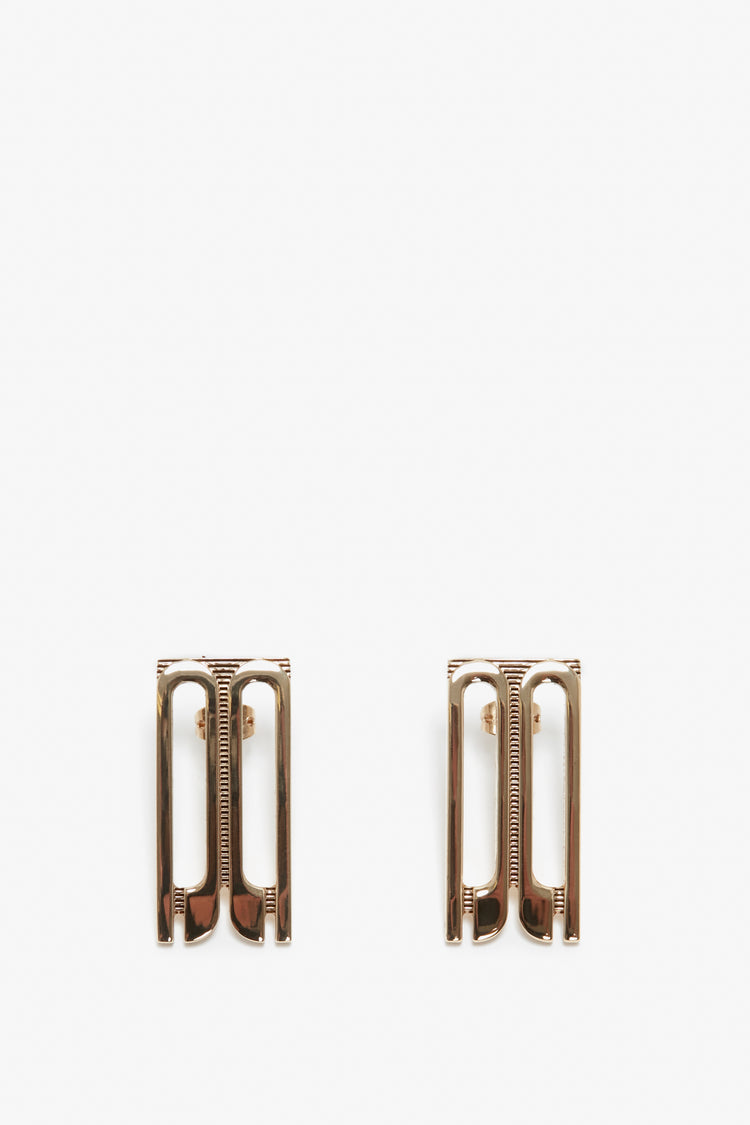 Two Victoria Beckham Exclusive Frame Stud Earrings In Gold placed symmetrically on a white background.