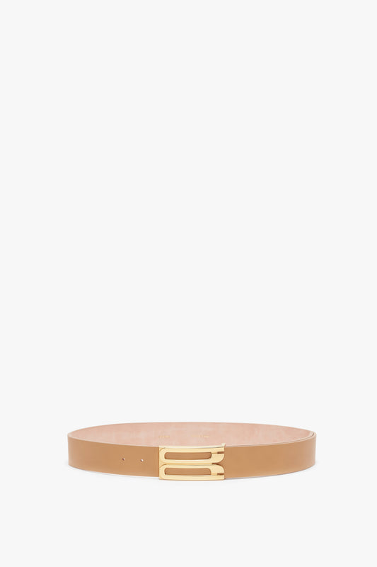 A Victoria Beckham Jumbo Frame Belt in Camel Leather with gold hardware, isolated on a white background.