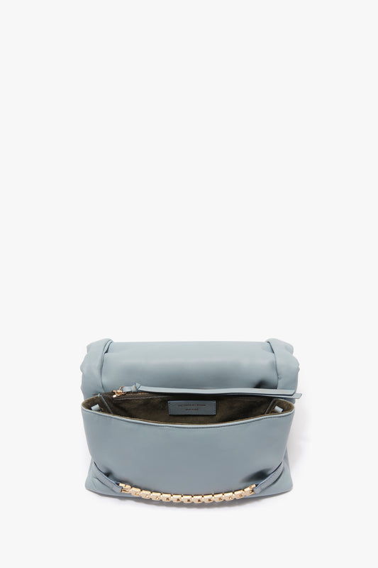Puffy Chain Pouch With Strap In Ice Leather handbag by Victoria Beckham, with an open top and partially visible interior label, isolated on a white background.