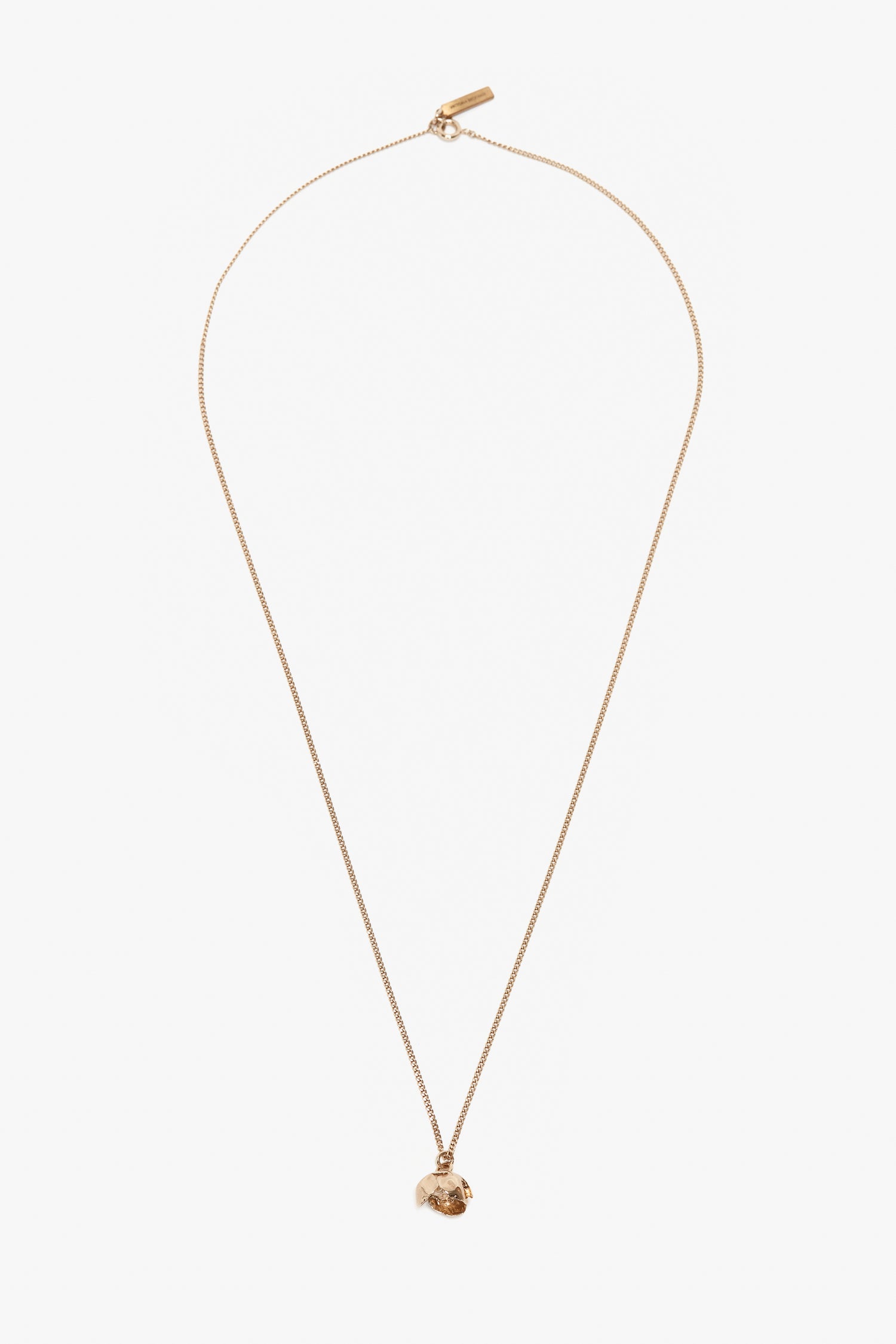 A thin Exclusive Camellia Flower Necklace In Gold, handcrafted in Italy by Victoria Beckham, featuring a small, irregularly shaped pendant on a white background.
