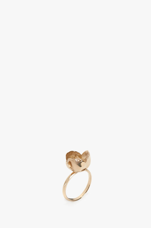 Exclusive Camellia Flower Ring In Gold-plated brass shaped like a fox with the head and tail meeting at the top, against a white background by Victoria Beckham.