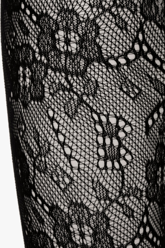 Close-up of Victoria Beckham's Exclusive VB Monogram Lace Tights In Black featuring a seamless and sag-free construction with intricate floral patterns.