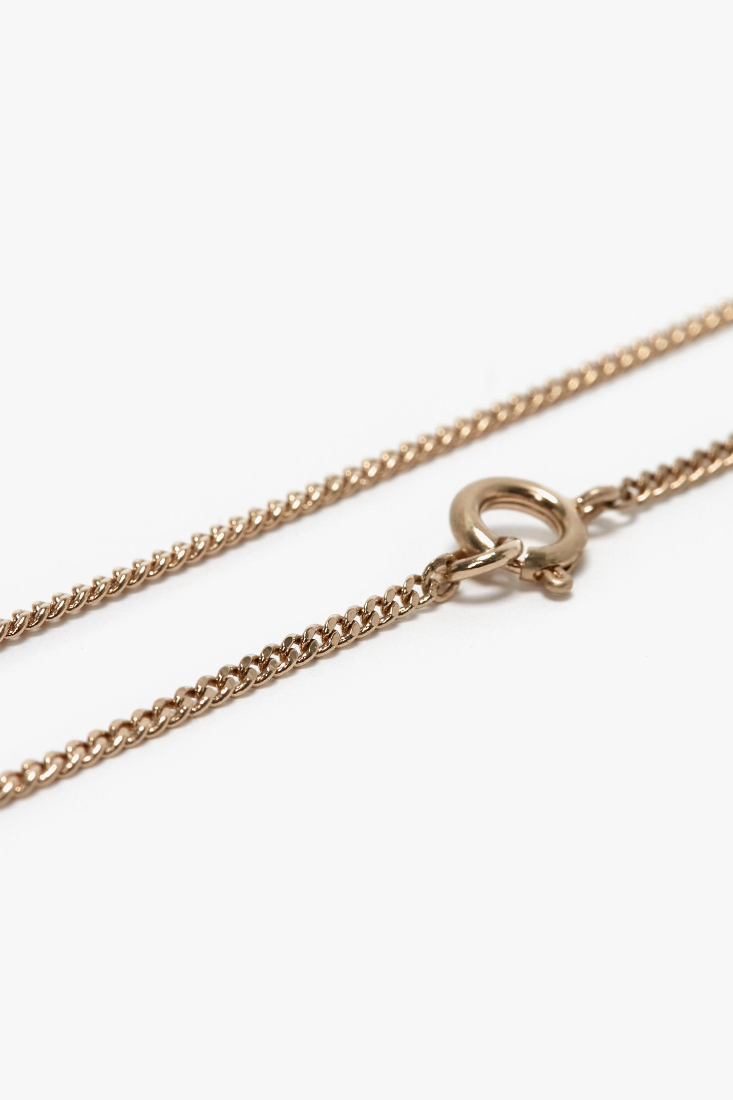 Close-up image of a delicate gold-plated brass Exclusive Long Fine Chain In Gold necklace by Victoria Beckham with a small, circular clasp.