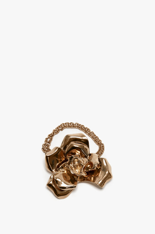 Exclusive Flower Bracelet In Gold by Victoria Beckham, with an adjustable chain detail, isolated on a white background.
