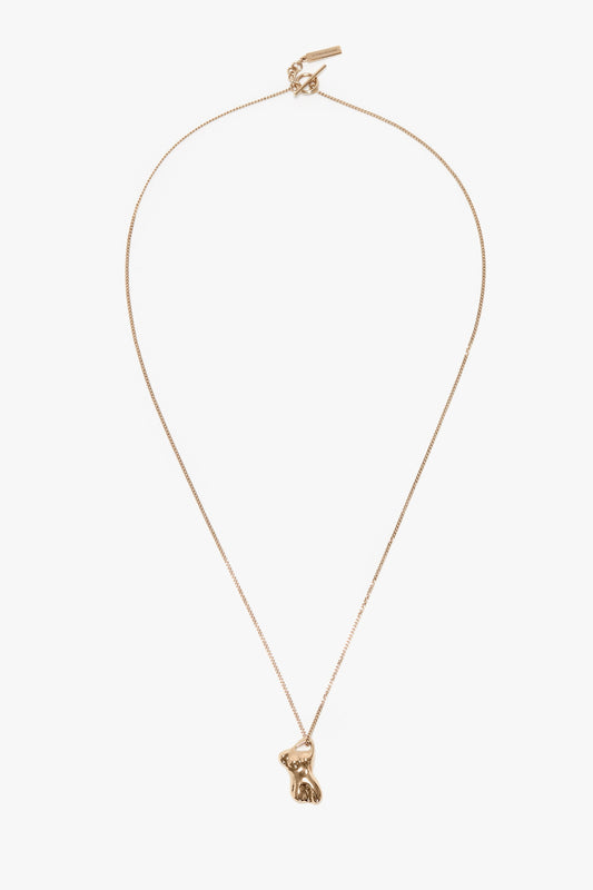 A Victoria Beckham Exclusive Body Charm Necklace In Light Gold featuring a small, detailed bunny pendant on a fine chain, crafted from 100% brass.