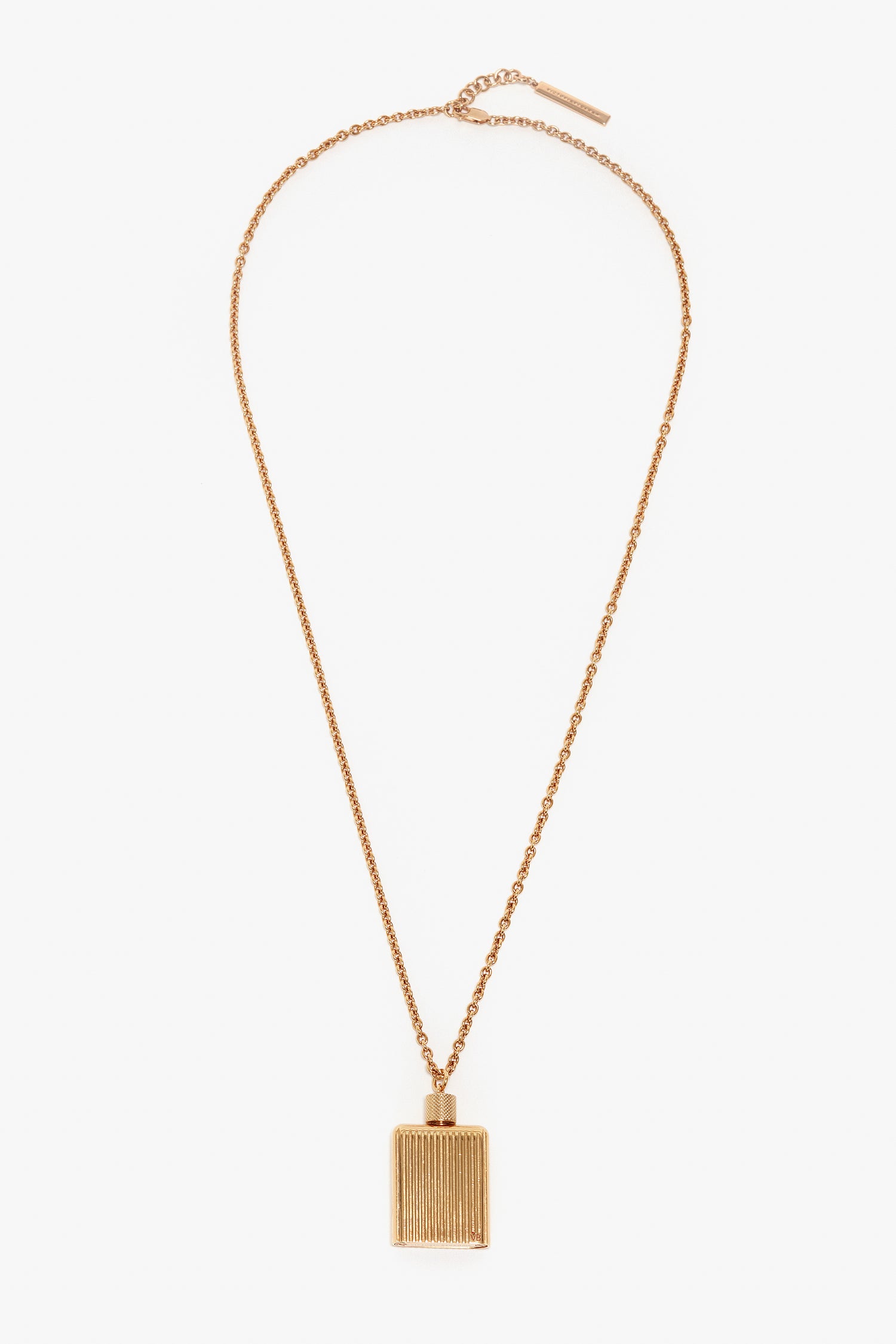A gold brushed brass chain necklace with a rectangular pendant featuring vertical grooves, reminiscent of the elegance found in Victoria Beckham Exclusive Perfume Bottle Necklace In Brushed Gold.
