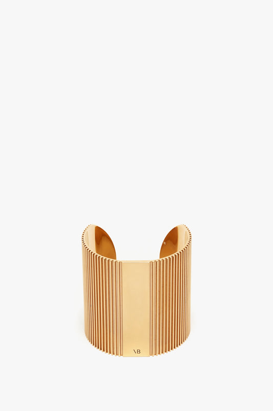 Exclusive Perfume Cuff In Gold cuff bracelet with vertical ribbed design, isolated on a white background by Victoria Beckham.