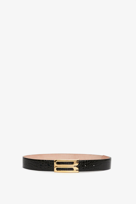 Jumbo frame belt in black croc-effect leather with a gold buckle, centered on a plain white background by Victoria Beckham.