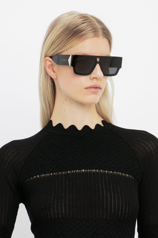 A woman wearing Victoria Beckham V Plaque Frame Sunglasses in Black.