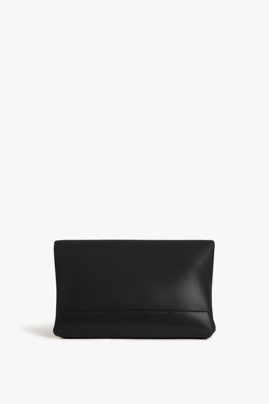 Chain Pouch Bag In Black Leather by Victoria Beckham with gold-tone hardware on a white background.