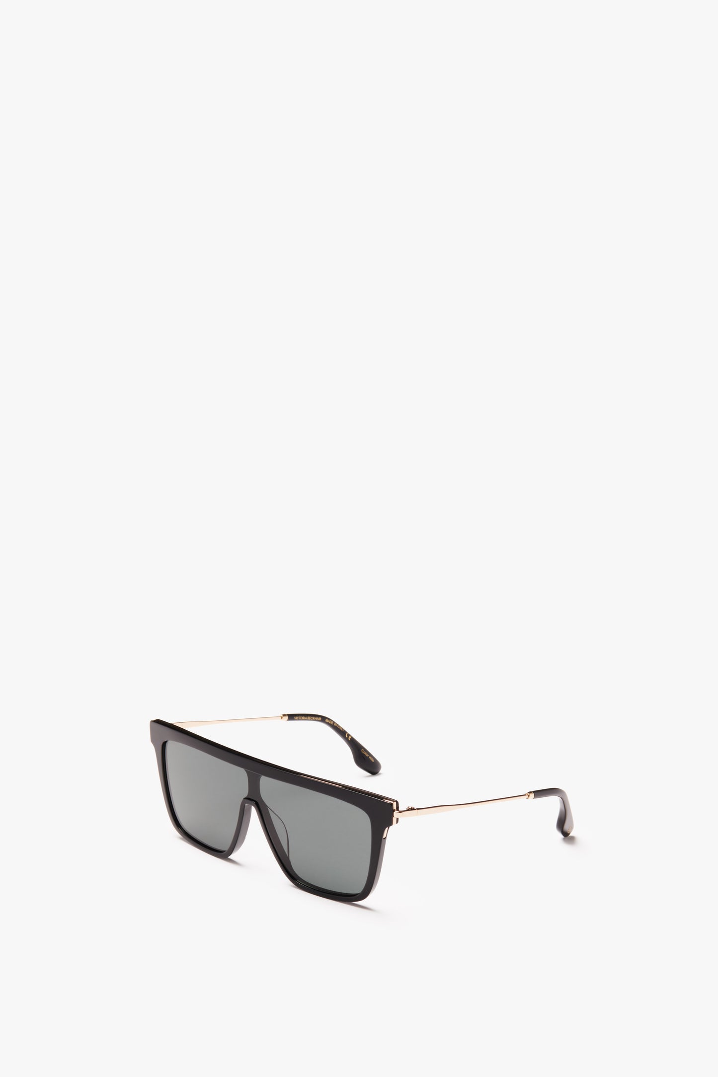 A pair of Rectangular Shield Sunglasses In Black with a thin gold frame, isolated on a white background, featuring the Victoria Beckham Eyewear design.