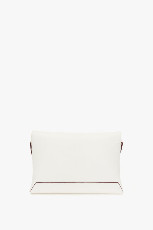 A plain white Victoria Beckham Nappa leather clutch purse with a minimalist design, positioned against a white background.