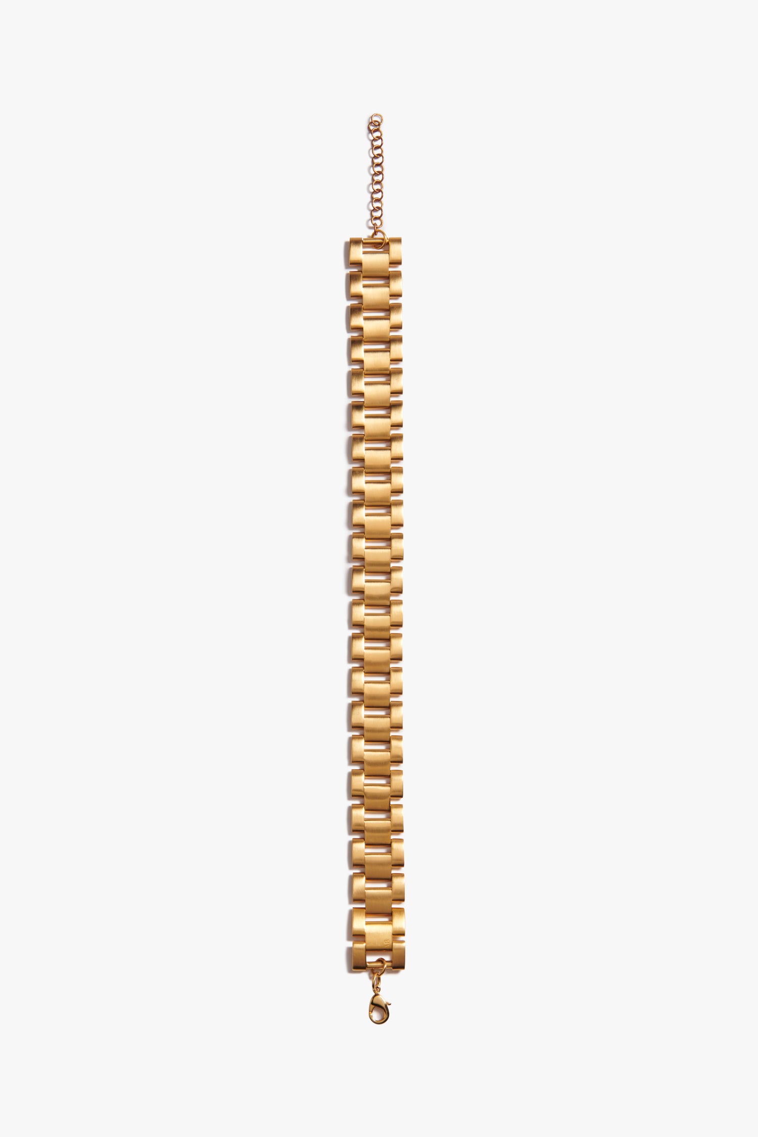 A Victoria Beckham Watch Chain Choker In Gold with a series of rectangular, watch-inspired links and an adjustable clasp, laid out flat on a white background.