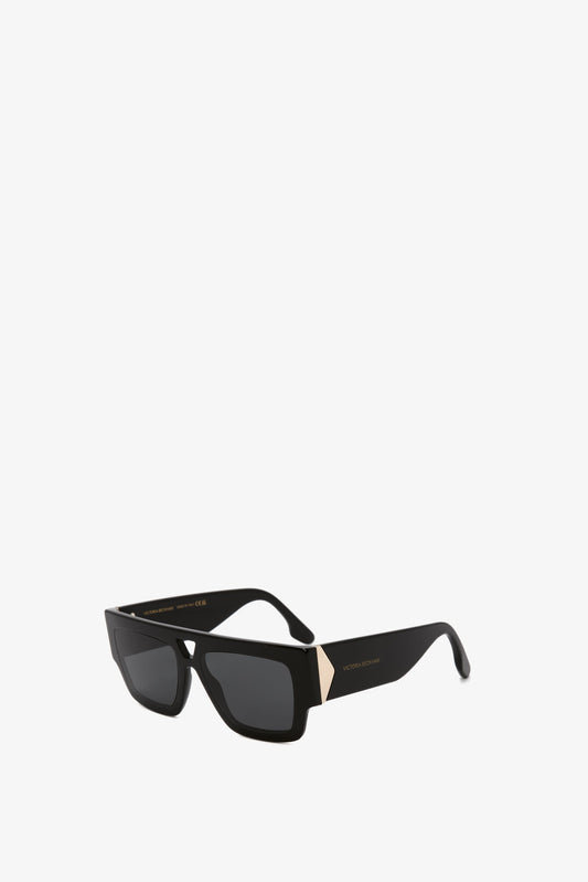 V Plaque Frame Sunglasses In Black by Victoria Beckham displayed against a white background.