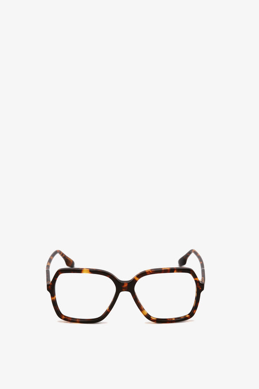 A pair of Victoria Beckham Guilloche Frame Opticals In Dark Havana with rectangular lenses, crafted from Dark Havana tortoise acetate, set against a plain white background.