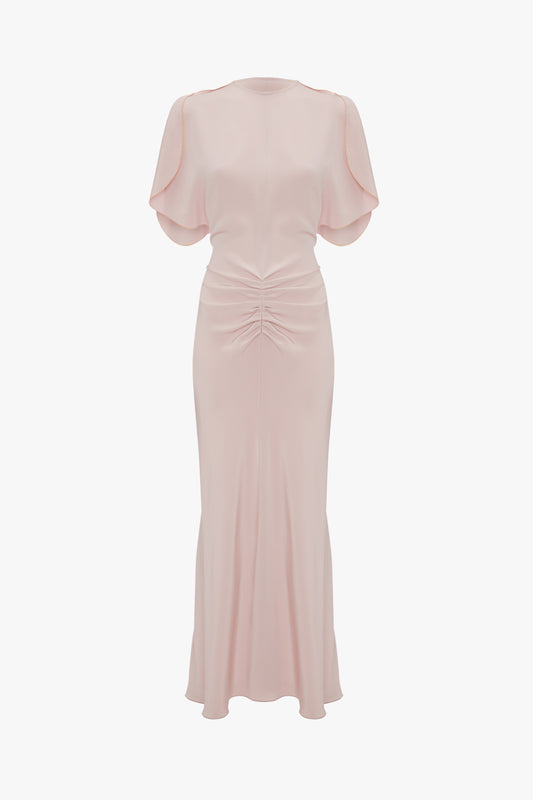 Elegant Victoria Beckham pastel pink evening dress with tulip sleeves, a ruched waist, and a floor-length skirt, displayed against a white background.
