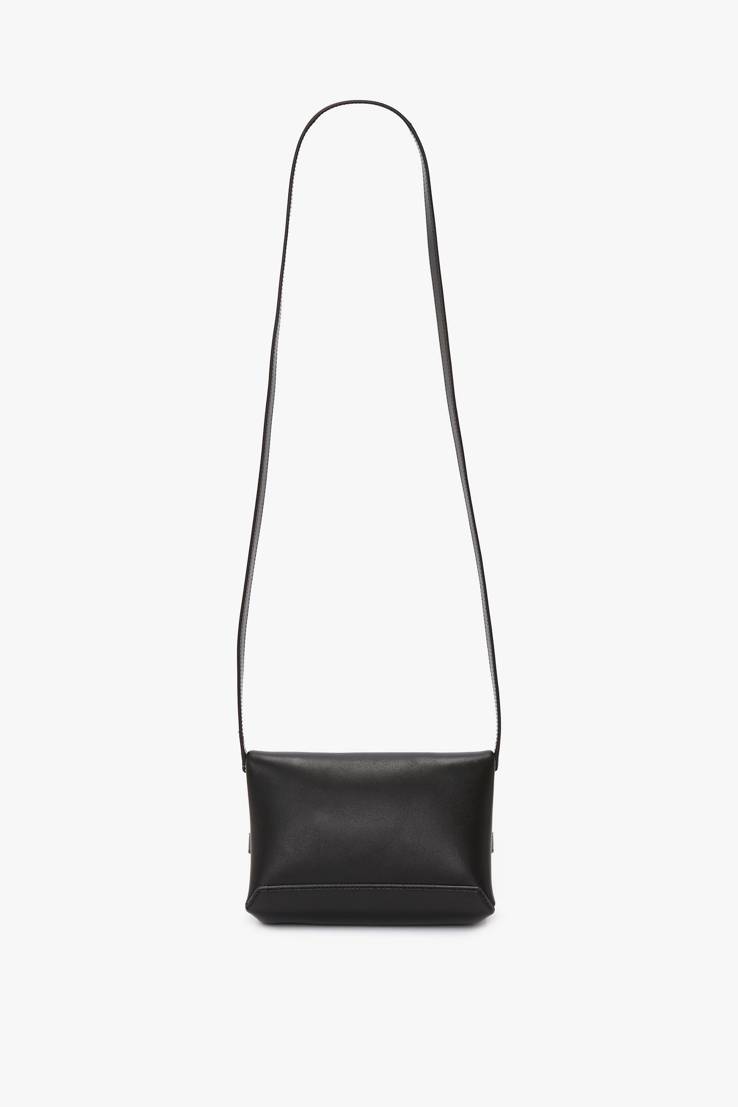 A Mini Chain Pouch Bag With Long Strap In Black Leather crafted from sumptuous black lambskin leather, featuring a long strap, is displayed against a plain white background. The elegant design is by Victoria Beckham.