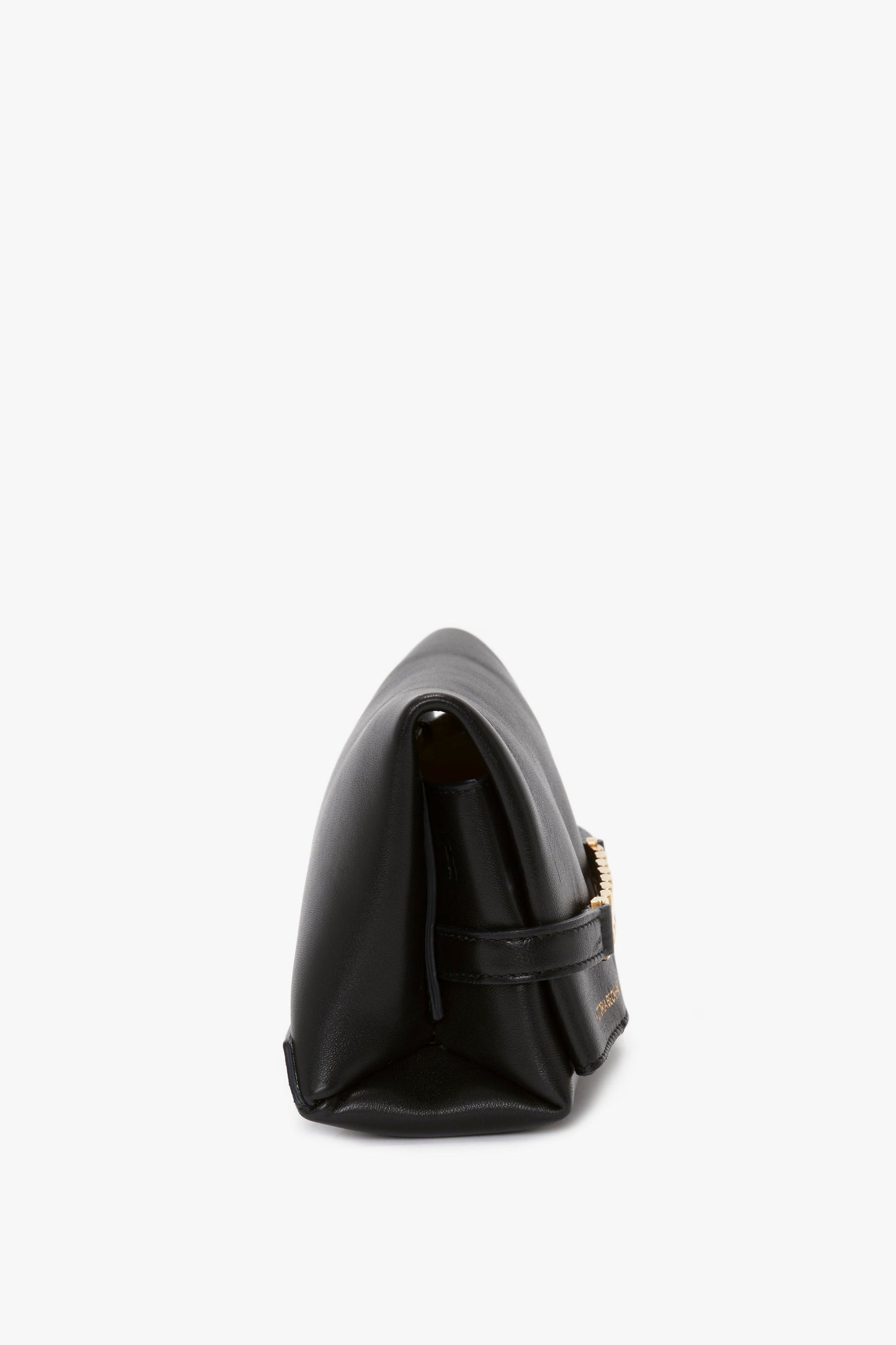 Side profile of a Victoria Beckham Mini Chain Pouch Bag With Long Strap In Black Leather with a visible gold clasp.