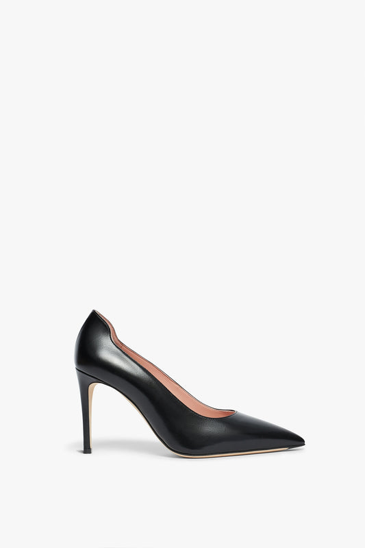 A VB Pump 90mm in Black stiletto heel shoe by Victoria Beckham with a smooth leather finish, handcrafted in Italy, side view.
