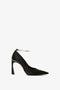 Side view of the Victoria Beckham Pointy Toe Pump in Black Satin with a pointed toe and an ankle strap featuring a gold buckle and a sleek 100mm heel.