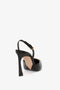 Pointy Toe Sling back in Black Calf by Victoria Beckham with an ankle strap, a square-shaped heel, and a subtle chain detail, viewed from the back against a white background.