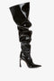 A black high-heeled knee-high boot with a slouchy design, versatile pointed toe, and shiny patent leather finish against a white background. Introducing the Thigh High Pointy Boot in Black Patent by Victoria Beckham.