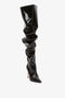 A single Victoria Beckham Thigh High Pointy Boot in Black Patent with a ruched design and a pointed toe, showcasing the versatility of thigh-high boots against a white background.