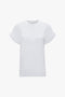 A Victoria Beckham Asymmetric Relaxed Fit T-Shirt In White displayed on a white background.