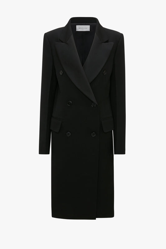 A Double Breasted Tuxedo Coat in Black by Victoria Beckham crafted from wool gabardine, featuring peaked lapels and two front pockets against a white background.