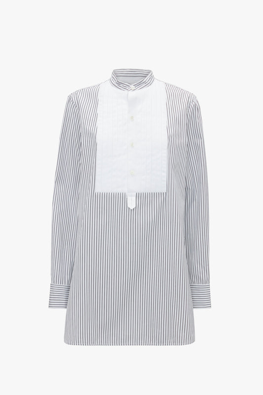 A long-sleeved, striped button-down shirt featuring a white vertical panel and a mandarin collar, designed with a roomy fit and inspired by classic menswear silhouettes for added style. This is the Tuxedo Bib Shirt in Black and Off-White by Victoria Beckham.