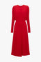 A red long-sleeve Dolman Midi Dress In Red by Victoria Beckham with a crew neckline and a fitted waist, shown against a plain white background.