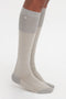 Close-up image of a person wearing Victoria Beckham Superfine Rib Socks In Lunar Grey with a small embroidered design near the top. The 100% cotton knee-high socks have the feet positioned side by side on a white background.