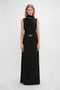 Person in a Tailored Floor-Length Skirt In Black by Victoria Beckham, featuring a structured silhouette, standing against a plain white background.