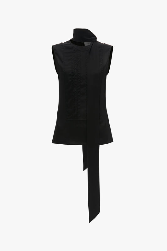 Victoria Beckham Sleeveless Tie Neck Top In Black with a high neckline and an attached luxurious double neck tie detail hanging down the front.