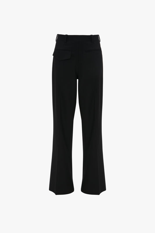These **Reverse Front Trousers In Black** by **Victoria Beckham**, featuring a straight cut with two back pockets and belt loops, offer a contemporary silhouette for the modern woman. Viewed from the back, these deconstructed trousers seamlessly blend style and functionality.