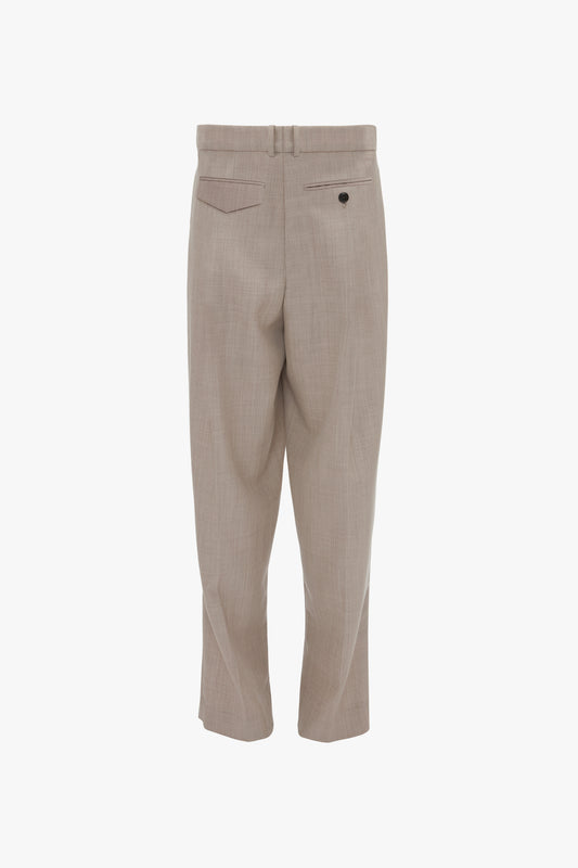 A pair of Victoria Beckham Reverse Front Trousers in Sesame shown from the back, featuring a contemporary silhouette with two pockets and a single button on one pocket.