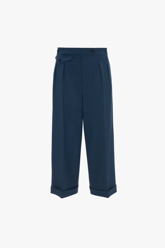 Navy blue wide leg cropped trousers with pleats and side pockets, displayed on a plain white background. 
**Wide Leg Cropped Trouser In Heritage Blue by Victoria Beckham**