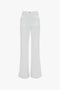 Victoria Beckham Alina High Waisted Jean In Washed White with front and back pockets, button and zipper closure.