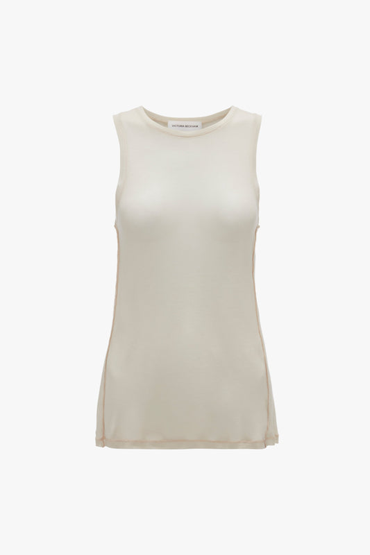 A sleeveless, beige top with a crew neckline and a smooth texture, displayed on a plain white background. This Lightweight Tank Top In Birch by Victoria Beckham is perfect for layering or wearing on its own.