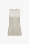 A sleeveless, beige top with a crew neckline and a smooth texture, displayed on a plain white background. This Lightweight Tank Top In Birch by Victoria Beckham is perfect for layering or wearing on its own.