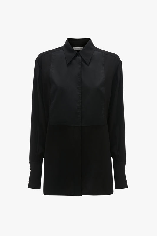 A timeless black, long-sleeve button-up shirt with a traditional collar and a square flap detail on the front, exuding modern femininity, the Contrast Bib Shirt In Black by Victoria Beckham.