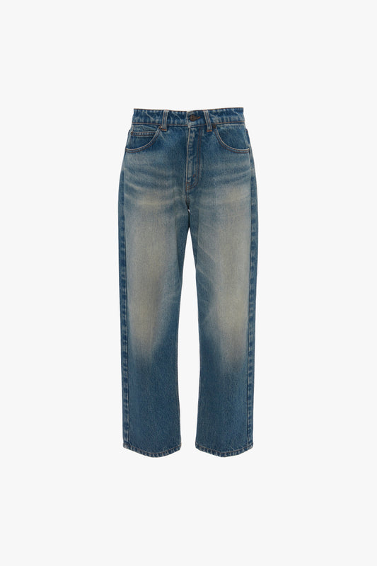 A pair of ankle-length Victoria Beckham relaxed straight leg jeans in antique indigo wash isolated on a white background.