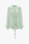 A Victoria Beckham Romantic Blouse In Jade with diaphanous blouson sleeves and a tie-neck detail.